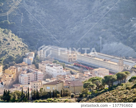 Peaceful Mountain Railway Hub Surrounded By Terraced Buildings And Flowing Tracks In Serene Valley Peaceful Mountain Railway Hub Surrounded By Terraced Buildings And Flowing Tracks In Serene Valley 137791602