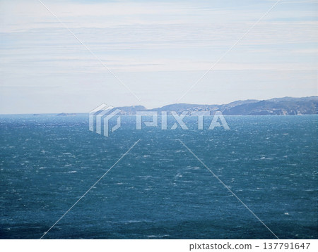Minimalist Seascape Showcasing Gentle Surface Textures And Distant Shoreline Under Pale Sky Minimalist Seascape Showcasing Gentle Surface Textures And Distant Shoreline Under Pale Sky 137791647