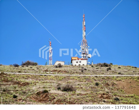 Outpost Of Telecommunication Infrastructure Standing Resilient On Desolate Hilltop Exposure Outpost Of Telecommunication Infrastructure Standing Resilient On Desolate Hilltop Exposure 137791648