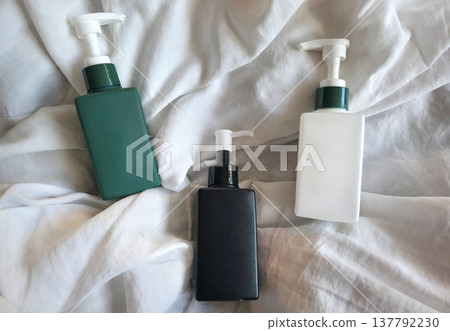 Colorful reusable containers for liquid cosmetic products in daily use on a textured background. Care products in a women's cosmetic bag. Skin care. Daily morning routine. High quality photo Colorful reusable containers for liquid cosmetic products in daily use on a textured background. Care products in a women's cosmetic bag. Skin care. Daily morning routine. High quality photo 137792230