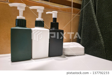 Colorful reusable containers for liquid cosmetic products in daily use on a textured background. Care products in a women's cosmetic bag. Skin care. Daily morning routine. High quality photo Colorful reusable containers for liquid cosmetic products in daily use on a textured background. Care products in a women's cosmetic bag. Skin care. Daily morning routine. High quality photo 137792233