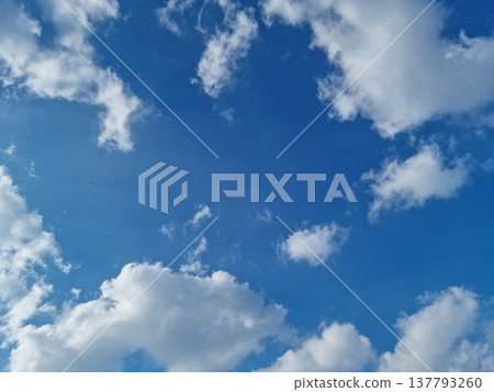 Blue sky and puffy clouds. 137793260