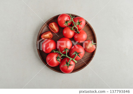A branch of pink cocktail tomatoes on wooden plate 137793846