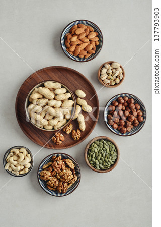 Walnuts, cashews, almonds, hazelnuts, peanuts, pistachios and pumpkin seeds in plates Walnuts, cashews, almonds, hazelnuts, peanuts, pistachios and pumpkin seeds in plates 137793903