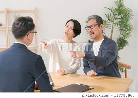 A middle-aged couple clashes with a salesman. A middle-aged couple clashes with a salesman. 137793963