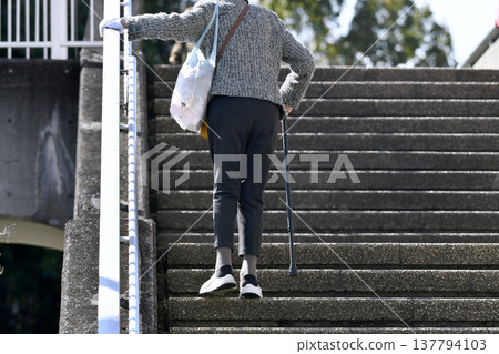 Yokohama cityscape stairs in Japan...an elderly woman with a cane...holding on to the handrail, barely able to climb...what is life...=Yokohama city 137794103