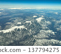 View of the Southern Alps, Central Alps, and Iida city from inside the aircraft. View of the Southern Alps, Central Alps, and Iida city from inside the aircraft. 137794275