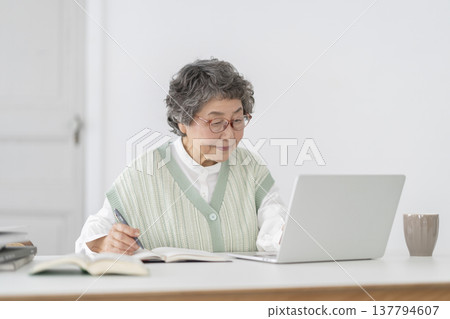 Senior woman doing desk work Senior woman doing desk work 137794607