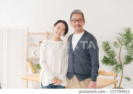 A smiling, happy-looking middle-aged couple 137794651