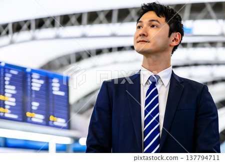 A businessman gazing at the future at the train station 137794711