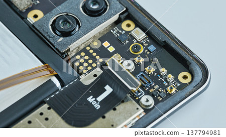 High-angle macro of circuit board, dual camera modules, and wireless charging coil High-angle macro of circuit board, dual camera modules, and wireless charging coil 137794981