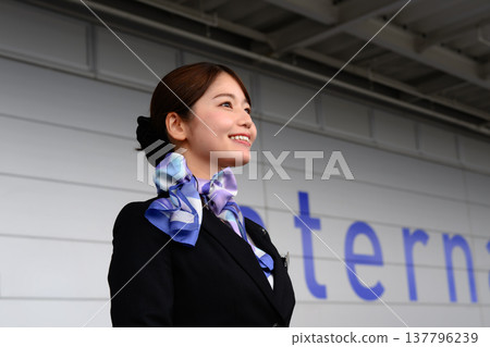 A flight attendant smiles at the airport. ■Filming assistance provided by: Kansai International Airport (KIX) 137796239