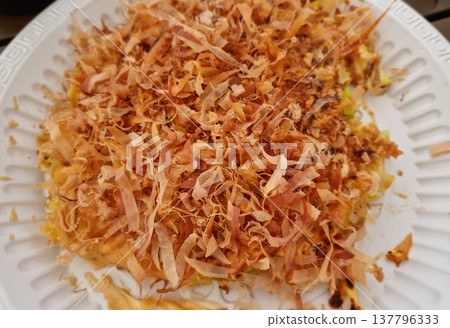This is okonomiyaki filled with bonito flakes. This is okonomiyaki filled with bonito flakes. 137796333