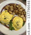 Eggs Benedict and potato brunch plate 137796648