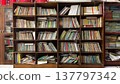 stacks and arrangements of books on library shelves 137797342