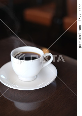 Hot coffee enjoyed in the morning sun Hot coffee enjoyed in the morning sun 137797772