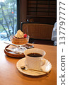 Coffee and pudding at a window seat in a coffee shop. 137797777