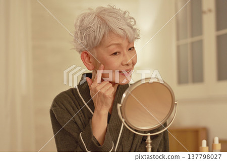 Senior woman's nighttime facial care Senior woman's nighttime facial care 137798027