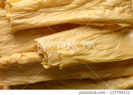 Dried bean curd skin or Yuba sheets, traditional Asian food ingredient, texture background Dried bean curd skin or Yuba sheets, traditional Asian food ingredient, texture background 137799122