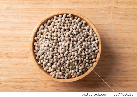 White peppercorn in a bowl on wooden background, Spices and seasoning, Table top view White peppercorn in a bowl on wooden background, Spices and seasoning, Table top view 137799133