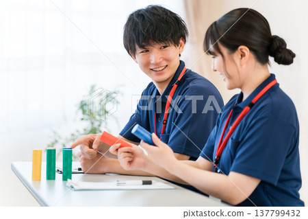 Male and female care workers and care managers receiving training (study group, meeting) Male and female care workers and care managers receiving training (study group, meeting) 137799432