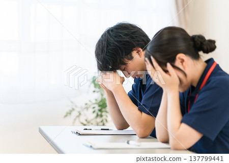 Fatigue, overworked caregivers, male and female care staff Fatigue, overworked caregivers, male and female care staff 137799441