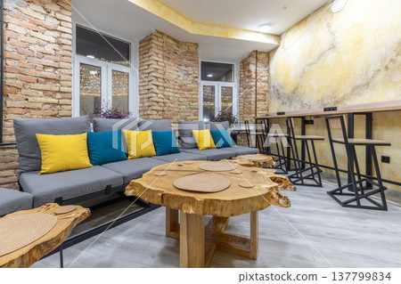 Industrial Hostel Lounge with Wood Slab Tables and Bar Seating Industrial Hostel Lounge with Wood Slab Tables and Bar Seating 137799834