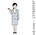 Full body shot of a woman in a suit giving directions. 137800597