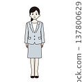 A woman in a suit standing upright (full body) 137800629