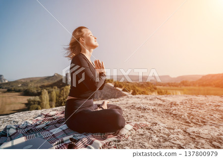Woman Meditating on a Mountaintop Woman Meditating on a Mountaintop 137800979