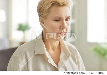 Pensive pleasant middle-aged aged woman face expression, alone looking sad thinking pondering 137801082