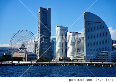 The cityscape of Yokohama Minato Mirai 21 and the blue sky, the Landmark Tower and the Ferris wheel. The cityscape of Yokohama Minato Mirai 21 and the blue sky, the Landmark Tower and the Ferris wheel. 137801525