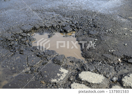 Potholes (holes in the asphalt) in the road Potholes (holes in the asphalt) in the road 137801583