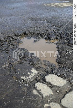 Potholes (holes in the asphalt) in the road Potholes (holes in the asphalt) in the road 137801584