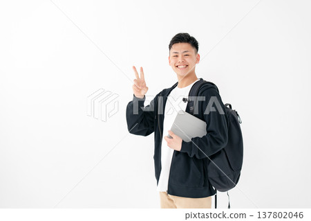Young man, casual, backpack, tablet Young man, casual, backpack, tablet 137802046