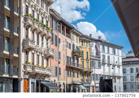 Milan, italy, april 1, 2024. Milan brera district street with colorful historic facades, balconies and shutters under a bright blue summer sky, picturesque cityscape 137802756