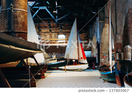 Boats inside a large building with wooden beams at a marina during the daytime Boats inside a large building with wooden beams at a marina during the daytime 137803067