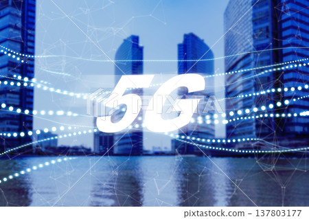 5G internet technology is seen in a city with tall buildings beside water during daytime 137803177