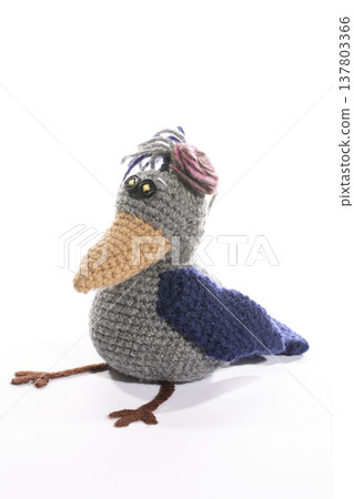 Knitted wool toy crow on a white background 137803366