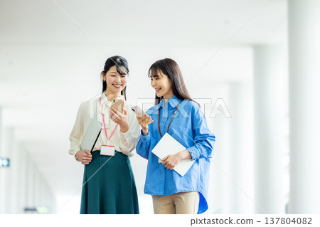 Business woman walking in the office corridor Business woman walking in the office corridor 137804082
