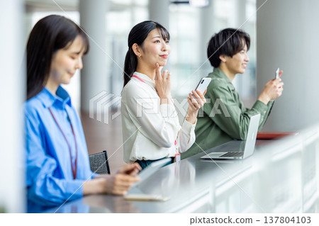 Men and women working in cafes Men and women working in cafes 137804103