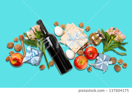 Passover items are arranged with flowers, wine, and matzah 137804175