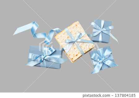 Matzah and wrapped gifts with ribbons arranged for Passover 137804185