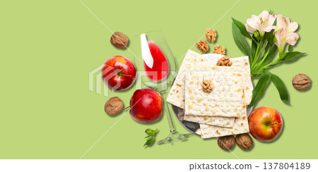 Matzah, apples, wine, walnuts, and flowers are arranged together 137804189