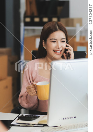 Starting small businesses SME owners female entrepreneurs check online orders to prepare to pack the boxes, sell to customers, sme business ideas online. Starting small businesses SME owners female entrepreneurs check online orders to prepare to pack the boxes, sell to customers, sme business ideas online. 137804257
