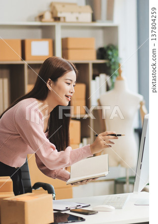 Starting small businesses SME owners female entrepreneurs check online orders to prepare to pack the boxes, sell to customers, sme business ideas online. 137804259