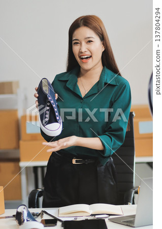 Starting small businesses SME owners female entrepreneurs check online orders to prepare to pack the boxes, sell to customers, sme business ideas online. Starting small businesses SME owners female entrepreneurs check online orders to prepare to pack the boxes, sell to customers, sme business ideas online. 137804294
