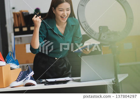 Starting small businesses SME owners female entrepreneurs check online orders to prepare to pack the boxes, sell to customers, sme business ideas online. Starting small businesses SME owners female entrepreneurs check online orders to prepare to pack the boxes, sell to customers, sme business ideas online. 137804297