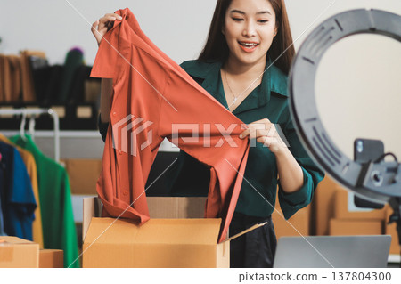 Starting small businesses SME owners female entrepreneurs check online orders to prepare to pack the boxes, sell to customers, sme business ideas online. Starting small businesses SME owners female entrepreneurs check online orders to prepare to pack the boxes, sell to customers, sme business ideas online. 137804300