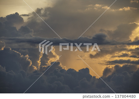 Beautiful sunset sky with a large sun covered by clouds. Beautiful sunset sky with a large sun covered by clouds. 137804480